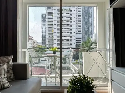 a living room with a large window with a view of a city at Contemporary Premier 1BR - Ultra Fast Wifi - BTS Nana in Bangkok