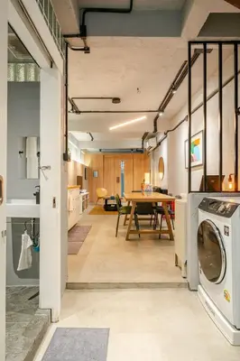 an open kitchen and dining room with a washer and dryer at Rare Bangkok Townhouse Perfect for Groups, 8 mins to Train in Bangkok