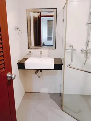 a bathroom with a sink and a mirror at XX Yon INN Sukhumvit 4- BTS Nana in Bangkok