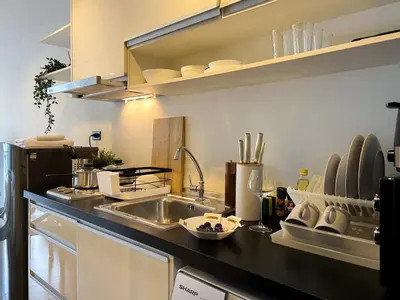 a kitchen with a sink and a counter top at Modern Cityscape1BR - Ultra Fast WiFi - BTS On nut in Bangkok