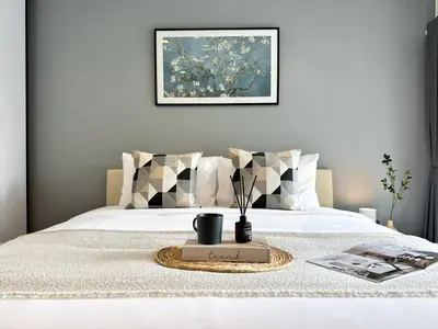 a bed with a tray with a plant on it at Modern Cityscape1BR - Ultra Fast WiFi - BTS On nut in Bangkok