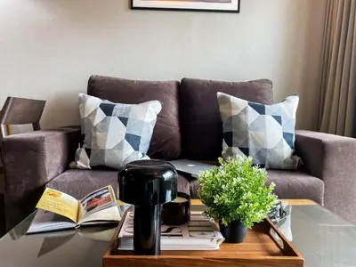 a living room with a couch and a coffee table at Tropical Urban 43 Sqm - Ultra Fast Wifi - Thong Lo in Bangkok