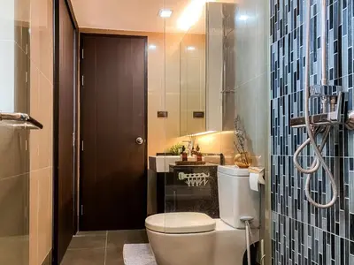 a bathroom with a toilet and a sink at Tropical Urban 43 Sqm - Ultra Fast Wifi - Thong Lo in Bangkok