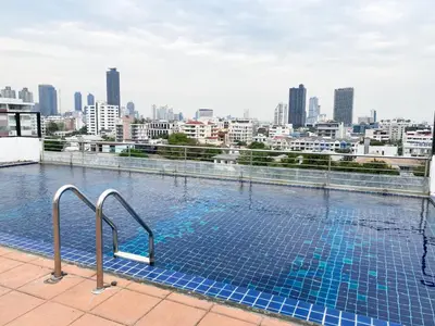 a swimming pool on top of a building with a city skyline at Tropical Urban 43 Sqm - Ultra Fast Wifi - Thong Lo in Bangkok