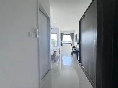 a hallway leading to a kitchen and a dining room at VS Place in Nonthaburi