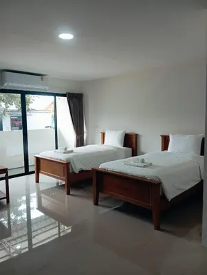 two beds sitting in a room with a window at VS Place in Nonthaburi