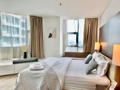 a bedroom with a large white bed and a window at Sathorn Prime Residence 2BR #Bangkok in Bangkok