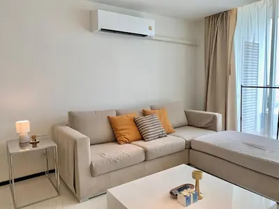 a living room with a couch and a table at Sathorn Prime Residence 2BR #Bangkok in Bangkok