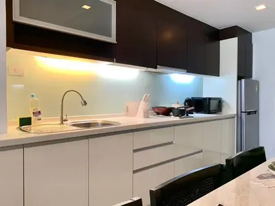 a kitchen with white cabinets and a sink at Sathorn Prime Residence 2BR #Bangkok in Bangkok