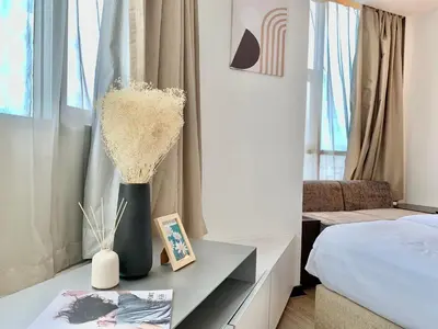 a bedroom with a table with a vase of flowers on it at Sathorn Prime Residence 2BR #Bangkok in Bangkok