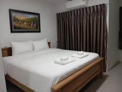 a bedroom with a bed with two towels on it at VS Place in Nonthaburi