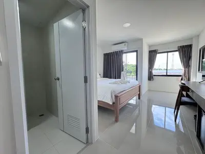 a bedroom with a bed and a walk in closet at VS Place in Nonthaburi