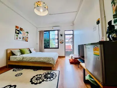 a bedroom with a bed and a tv in it at Gallery house 177-3min walk BTS near icon siam in Bangkok