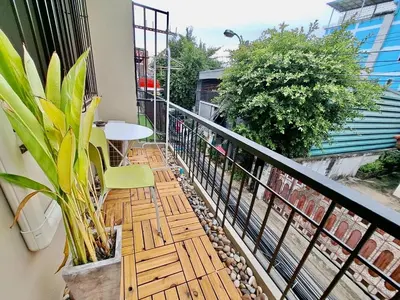 a balcony with a table and chairs on a balcony at Gallery house 177-3min walk BTS near icon siam in Bangkok