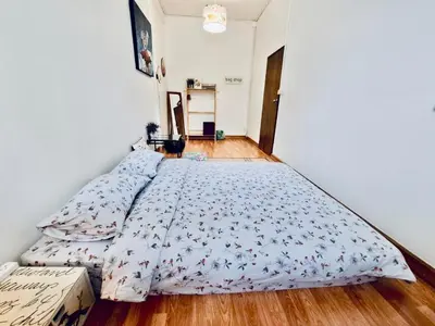 a bedroom with a bed with a blue comforter at Gallery house 177-3min walk BTS near icon siam in Bangkok