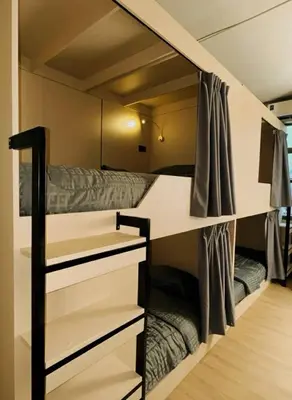 a small room with a bunk bed in a room at Holy Hostel Sathorn in Thung Maha Mek