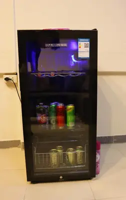 a small refrigerator with drinks and cans of soda at Holy Hostel Sathorn in Thung Maha Mek