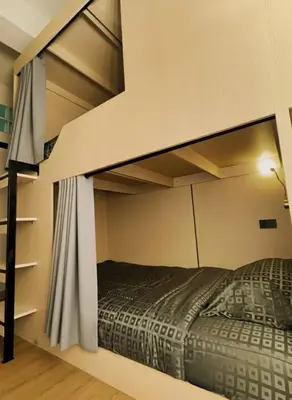 a bedroom with a bunk bed in a room at Holy Hostel Sathorn in Thung Maha Mek