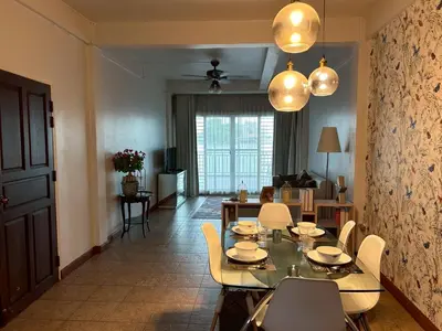 a dining table and chairs in a living room at บ้านริมน้ำ bann rim num in Bangkok