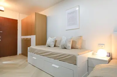 a white bedroom with a bed and a cabinet at 4 guests condo near Impact, Wi-Fi & washer C5 in Ban Bang Phang