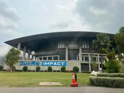 a building with a blue sign in front of it at 4 guests condo near Impact, Wi-Fi & washer C5 in Ban Bang Phang