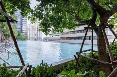 a large swimming pool in the middle of a city at One9Five Asoke Rama 9 \u6708\u79df 500mbps wifi in Bangkok