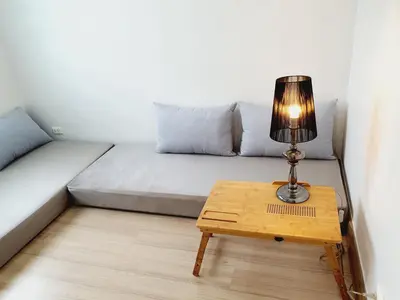 a couch with a table with a lamp on it at Comfy Townhome 5min walk to 7-11 in Ban Nong Bua