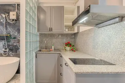 a kitchen with white cabinets and a sink at Rooftop at Ladprao The Mall Bangkapi BTS 4BR with Lift in Ban Bang Toei (1)
