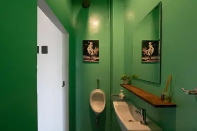 a green bathroom with a urinal and a sink at Rooftop at Ladprao The Mall Bangkapi BTS 4BR with Lift in Ban Bang Toei (1)