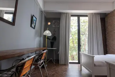 a bedroom with a bed and a desk and a window at Rooftop at Ladprao The Mall Bangkapi BTS 4BR with Lift in Ban Bang Toei (1)