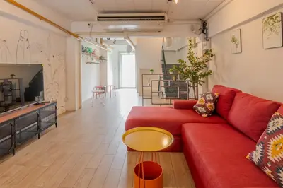 a living room with a red couch and a fireplace at Rooftop at Ladprao The Mall Bangkapi BTS 4BR with Lift in Ban Bang Toei (1)