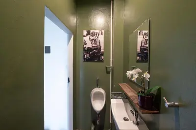 a green bathroom with a urinal and a sink at Rooftop at Ladprao The Mall Bangkapi BTS 4BR with Lift in Ban Bang Toei (1)