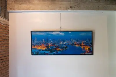 a tv hanging on a wall with a view of a city at Rooftop at Ladprao The Mall Bangkapi BTS 4BR with Lift in Ban Bang Toei (1)