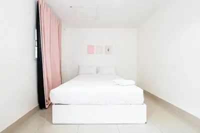 a small white room with a bed in it at XX Oh My Nap BTS Nana - โอ้ มาย แน็ป บีทีเอส นานา in Bangkok