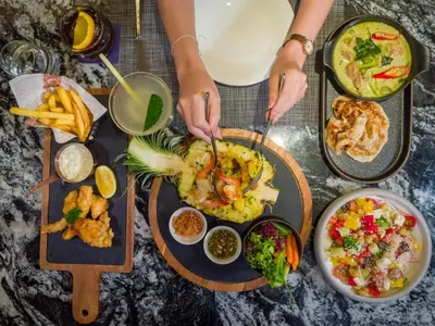 a table with a bunch of food on it at Away Bangkok Sukhumvit in Bangkok