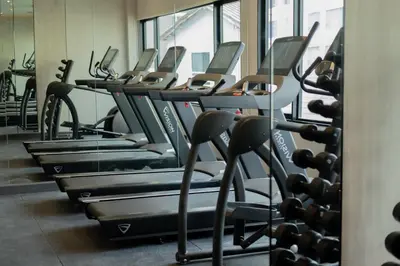 a row of cardio machines in a gym at Away Bangkok Sukhumvit in Bangkok