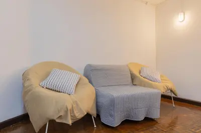 a room with two ottomans and two chairs at Calmly Stay Ratchada in Bangkok