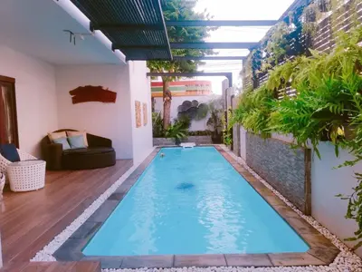 a swimming pool in the middle of a house at Yotaka Boutique Hotel Bangkok in Bangkok