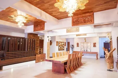 a dining room with a wooden table and chairs at Yotaka Boutique Hotel Bangkok in Bangkok