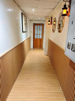 a hallway leading to a door in a building at latitude 13 Room & breakfast in Bangkok