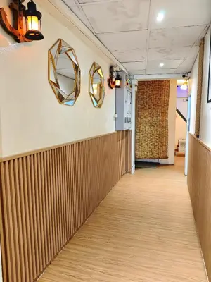 a hallway with two mirrors on the wall at latitude 13 Room & breakfast in Bangkok