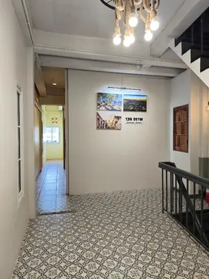 a hallway with a wall with a picture on it at latitude 13 Room & breakfast in Bangkok