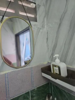 a mirror and a soap dispenser in a bathroom at 214 Lovely apartment with private bathroom and WiFi in Bangkok