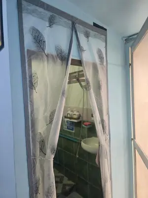 a shower curtain in a bathroom with a sink at 214 Lovely apartment with private bathroom and WiFi in Bangkok