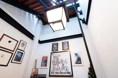 a room with pictures on the wall and a light at The Secret Service in Bangkok