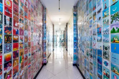 a hallway of a building with many pictures on the walls at The Secret Service in Bangkok
