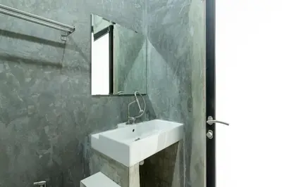 a bathroom with a white sink and a mirror at The Secret Service in Bangkok