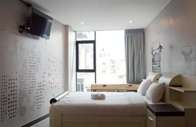 a bedroom with a bed and a large window at The Secret Service in Bangkok