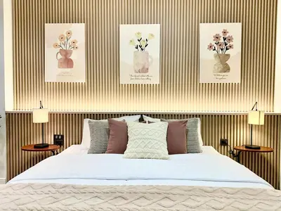 a bedroom with a bed with flowers in vases at Studio Botanica I 2 mins to SRT in Bangkok