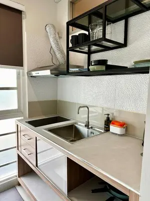 a small kitchen with a sink and a counter at Indigo Studio 2 mins from SRT Wat Samien Nari in Bangkok